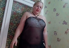 Voluptuous blonde in sheer pantyhose teases with exposed curves