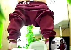 Japanese girl hunkering while pissing spied on camera