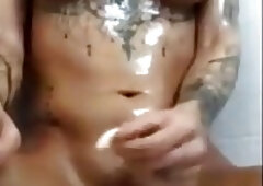 Luscious shemale with sexy tattoos oiled up for solo masturbation