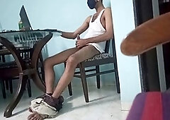 Young Indian guy milking himself at the dining table