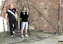 The boy is restrained in a cage of metal and blindfolded