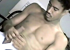 Muscular man with large ebony dick masturbating with greased beard