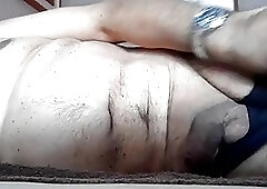 Hairy crossdressing shemale teases her cock before stroking it passionately