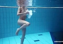 Flat chested chick is happy to demonstrate her bum while swimming