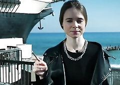 Pretty youthful Russian angel smokin' one cigarette outdoors on terrace, natural daylight, relaxed mood, soft expressions, casual lifestyle posin