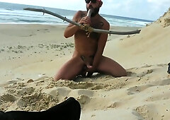 guy fucks himself on the beach with a wooden dildo