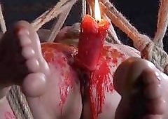 Suspended brunette slave cries as she receives massive hot waxing