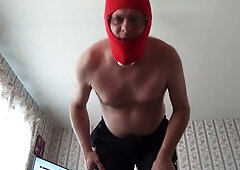 Masked muscular man in red balaclava jerks off on camera