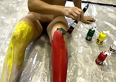 British brunette paints her nude body in vibrant colors on a kitchen floor
