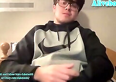 nerd guy in glasses strokes his dick on webcam