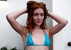 Redheaded solo vixen Jia Lissa spreads wide in the sun and plays with her hairy pussy