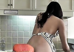 Large booty ladyboy in colorful apron gets drilled on the table