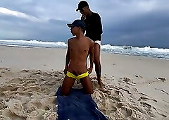 Passive twink showing his ass on the beach in front of everyone.