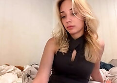 Hot Blonde Teasing in Tight Black Dress on Bed