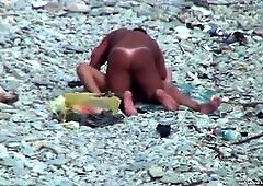 Voyeur. Guy with tanned ass fuck a woman at a public beach