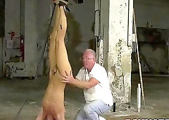 Submissive twink tied up upside down for a BDSM session