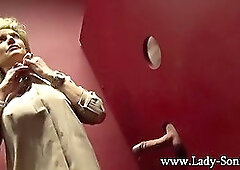 Busty milf Lady Sonia milking a huge dick on the gloryhole