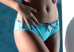 A girl with a sexy ass is teasing her pussy lips before us