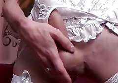 Busty brunette strips naughty lingerie while stroking her tranny schlong