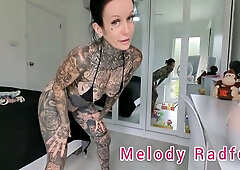 Sun-kissed Australian MILF Melody Radford slowly slips into a tiny red G-string and micro bikini for a private bedroom lingerie session