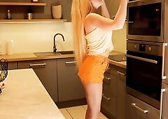Lengthy hair lengthy legs sexy golden-haired college cutie on high heels and a miniskirt which does not cover her butt in the kitchen