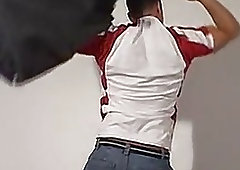 Handsome jock performs a striptease before having his feet tickled