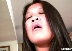 Busty chick Kat Young fondles her pussy sitting on top of kitchen counter