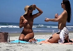 Beach voyeur captures two beautiful naked babes sunbathing
