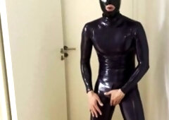 Gay amateur in skin-tight rubber catsuit and mask indulges in homemade solo masturbation