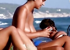 2 hot cuties topless in the beach enjoying the sunny day.