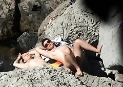 Beach voyeur finds a lovely amateur babe enjoying the sun