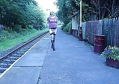 Crossdressed outdoors on a public railway platform