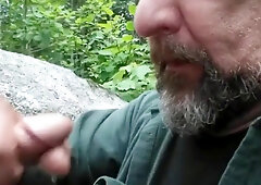 Older guy has fun sucking a younger guys cock in the park