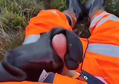 Worker In Hiviz Rain Gear And Rubber Boots