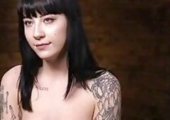 Slim, tattooed brunette is using a sex machine to satisfy her sexual needs, while being tied up