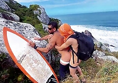 A cheeky surfer getting a prick and urinate from a tourist.