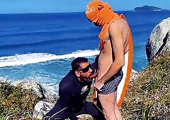 A cheeky surfer getting a prick and urinate from a tourist.