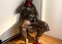 Crossdresser in red mules indulges in plastic fetish attire while getting jizzed on