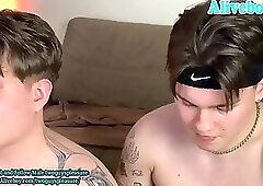 two guys with tattoos have pleasure on webcam