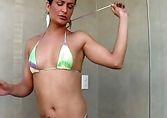 Bikini tgirl beauty is tugging good sized cock in the shower