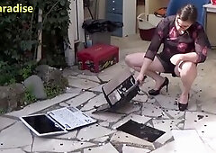 Hot woman destroys two laptops with her high heels and with a hammer