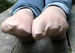 Jeans Feet In Nylon Socks In The Forest