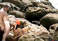 A female tourist receives a facial during the time that on rocks.