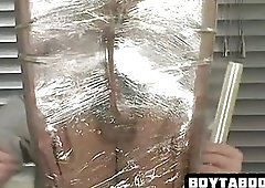 Horny stud gets saran wrapped before getting tugged