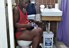 Watch this American MILF with black hair get down and dirty in the toilet