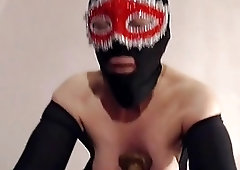 Masked chick gets her cute nipples stretched out real hard