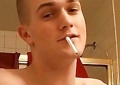 Gay jock smoking with a passion while stroking his dick