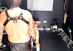 Punishment fulfillment for the submissive slave under the strict leather master