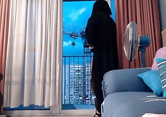 exhibits in niqab in front of a crane operator