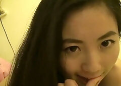 Taiwanese girl Lin Xiaoxia explores her body in private on a dimly lit bed